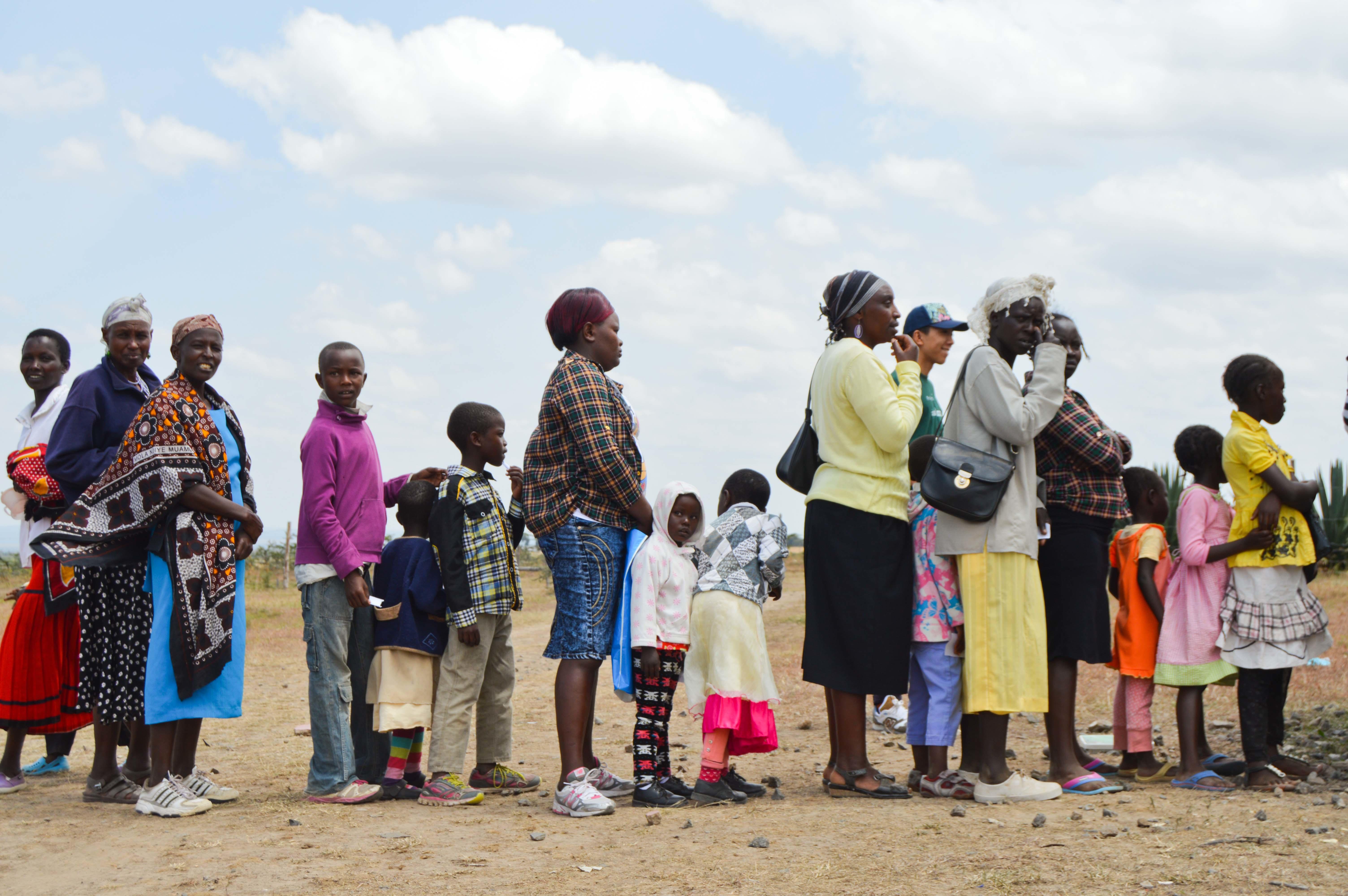 Local families queue up to recieve medical attention during a Medical Outreach ran by Project Abroad Medical Interns in Kenya. Medical interns treat local families at a medical outreach day during their Work Experience Placement in Kenya.